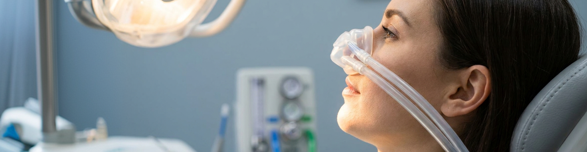 Dental patient relaxing in a treatment chair while receiving nitrous oxide sedation through a nasal mask.
